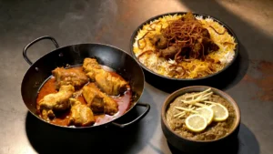 chicken-karahi-in-a-black-wok-biryani-with-crispy-onions-and-haleem-with-lemon-served-on-a-dark-stone-surface-for-eid-al-fitr