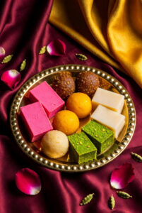 assorted-pakistani-and-indian-mithai-traditional-sweets-including-barfi-ladoo-jalebi-and-peda-arranged-on-a-gold-tray-for-eid